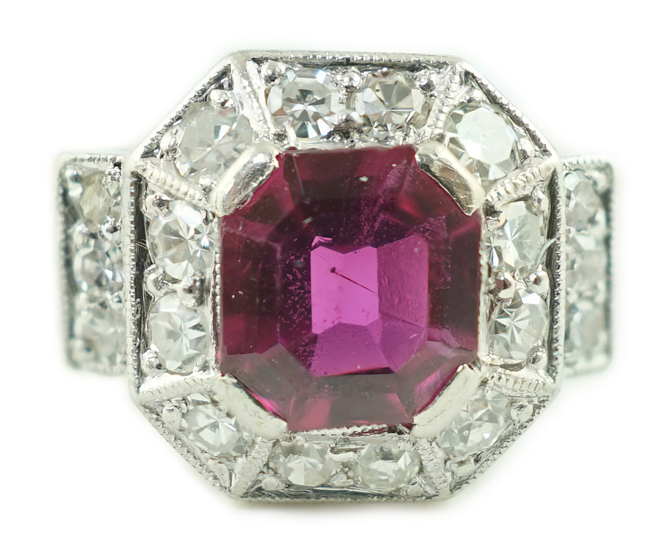 A 1950's Art Deco 18ct gold and platinum, ruby and millegrain set diamond octagonal cluster ring